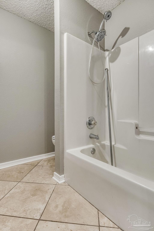 321 Loveland Cir, Pensacola, FL 32526 - full bath with tile patterned flooring, toilet, washtub / shower combination, baseboards, and a textured ceiling
