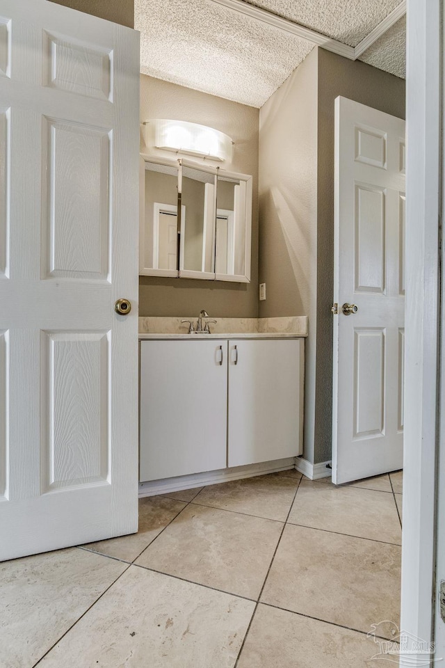 bathroom featuring vanity, a textured ceiling, and tile patterned flooring