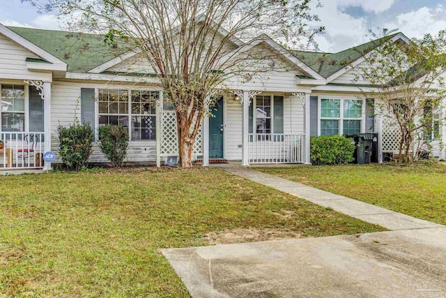 321 Loveland Cir, Pensacola, FL 32526 - view of front facade with covered porch, a front yard, and roof with shingles