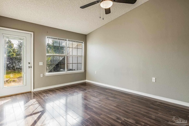 empty room with ceiling fan, a textured ceiling, and dark hardwood / wood-style flooring