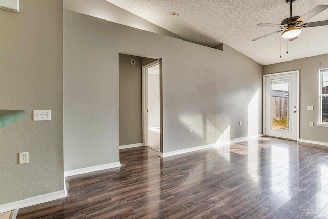 interior space with ceiling fan, a textured ceiling, vaulted ceiling, and dark hardwood / wood-style floors