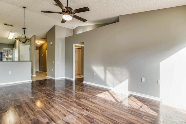 unfurnished living room with ceiling fan, a textured ceiling, high vaulted ceiling, and dark hardwood / wood-style flooring