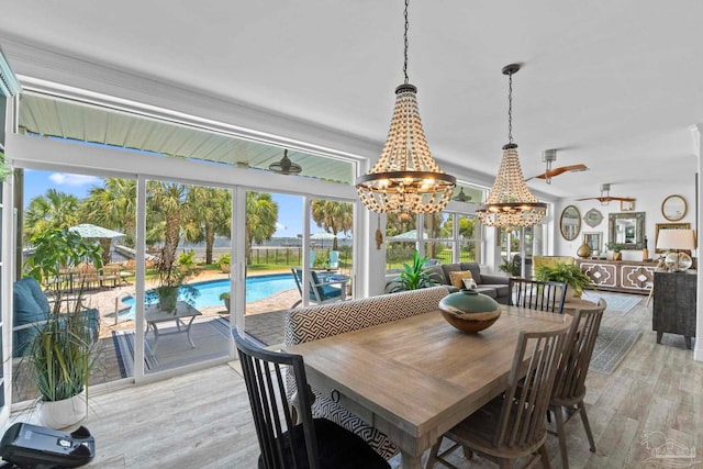 8209 Pompano St, Navarre, FL 32566 - dining space with a chandelier and light wood-style floors