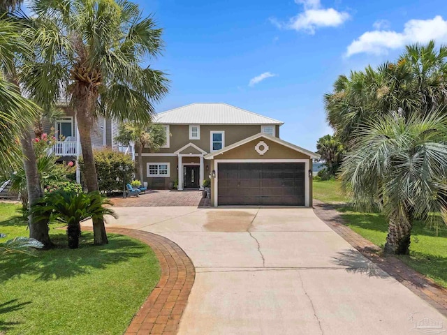 8209 Pompano St, Navarre, FL 32566 - view of front of property featuring concrete driveway, an attached garage, stucco siding, and a front yard