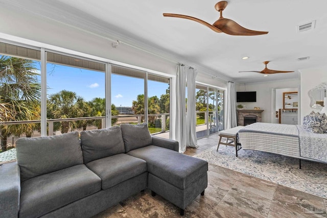 8209 Pompano St, Navarre, FL 32566 - bedroom with access to outside, ornamental molding, a fireplace, and a ceiling fan