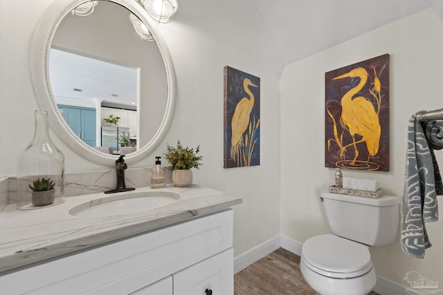 8209 Pompano St, Navarre, FL 32566 - half bath featuring vanity, wood finished floors, and lofted ceiling