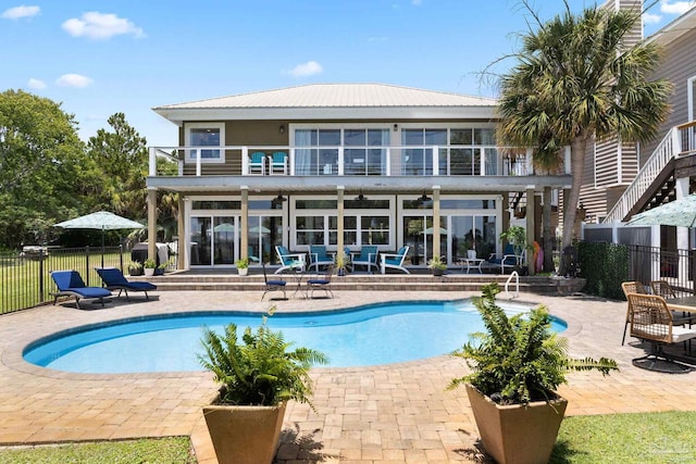 8209 Pompano St, Navarre, FL 32566 - back of house with a balcony, a patio area, and a metal roof
