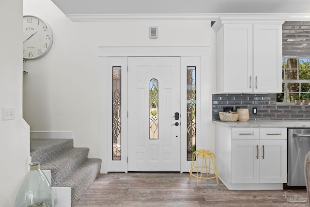8209 Pompano St, Navarre, FL 32566 - foyer entrance featuring wood finished floors, stairway, and crown molding
