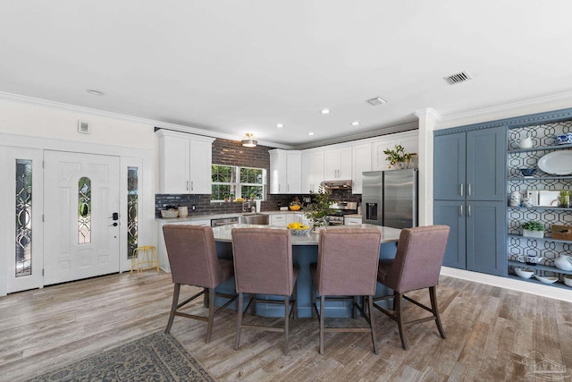 8209 Pompano St, Navarre, FL 32566 - dining space with crown molding, light wood-style flooring, and recessed lighting
