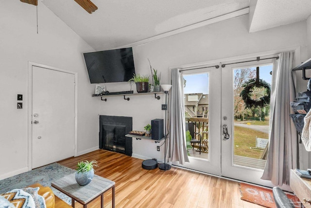 living room featuring hardwood / wood-style floors, french doors, and ceiling fan