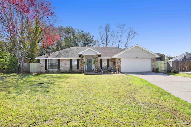 single story home featuring an attached garage, brick siding, fence, concrete driveway, and a front lawn