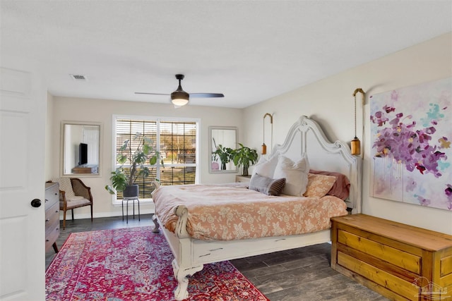 bedroom with dark wood-style floors, baseboards, visible vents, and a ceiling fan