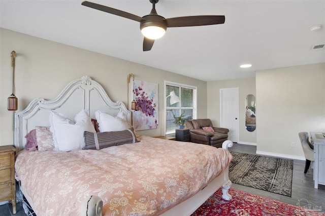 bedroom with visible vents, baseboards, ceiling fan, and wood finished floors