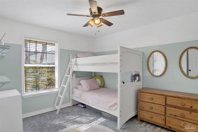 carpeted bedroom with baseboards and a ceiling fan