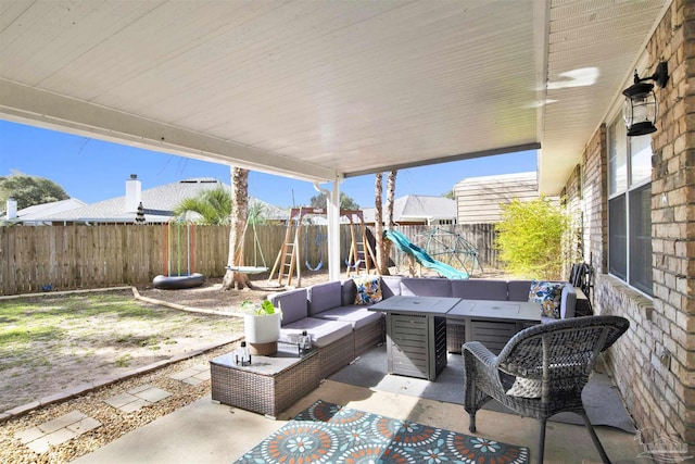 view of patio / terrace with a fenced backyard, an outdoor hangout area, and a playground