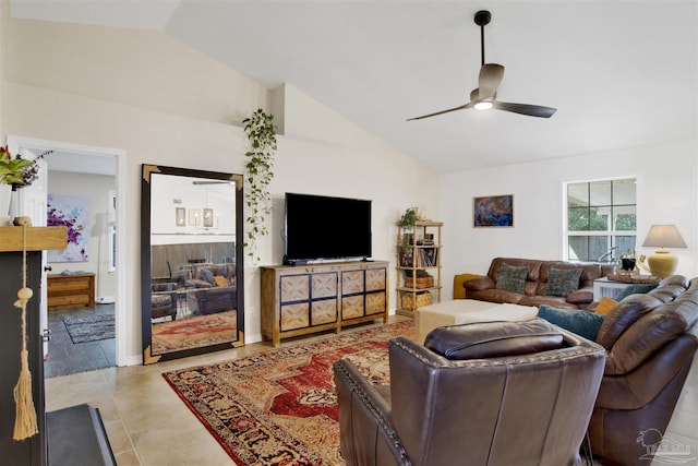 living area featuring light tile patterned floors, ceiling fan, and vaulted ceiling