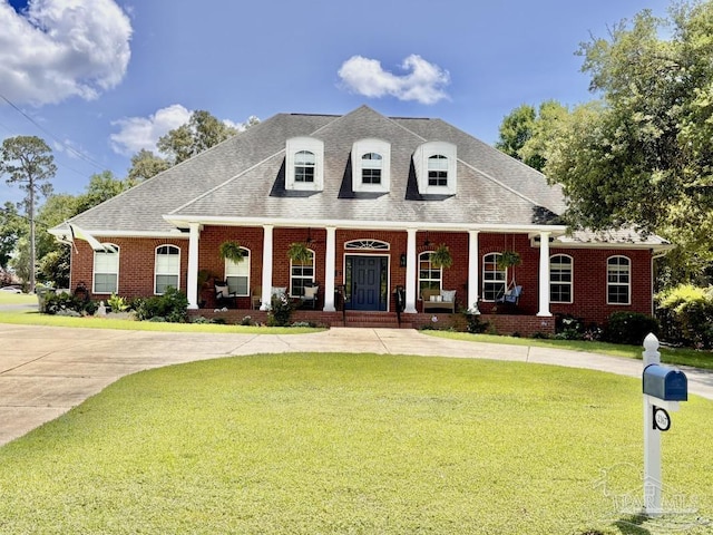 2367 Greenbrier Blvd, Pensacola, FL 32514 - view of front of home featuring a porch, a front yard, brick siding, and a shingled roof