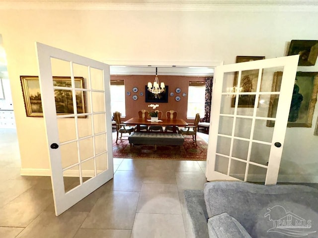2367 Greenbrier Blvd, Pensacola, FL 32514 - tiled dining room featuring a chandelier, crown molding, healthy amount of natural light, and french doors