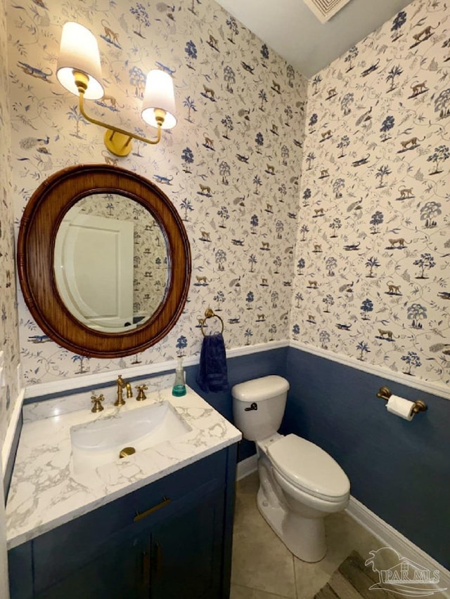 2367 Greenbrier Blvd, Pensacola, FL 32514 - bathroom with wallpapered walls, vanity, toilet, tile patterned floors, and wainscoting