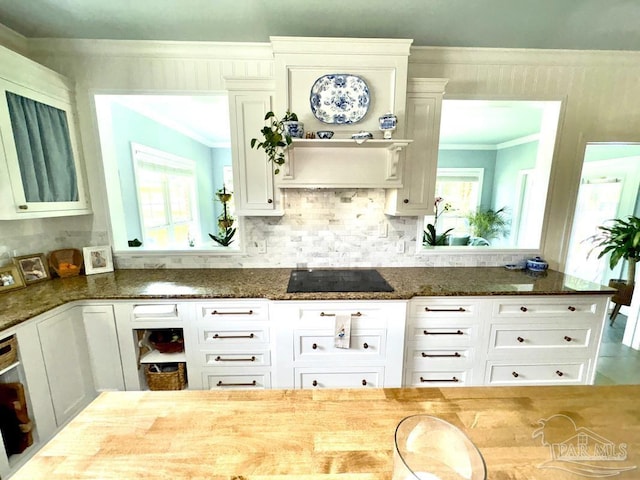 2367 Greenbrier Blvd, Pensacola, FL 32514 - kitchen featuring crown molding, dark stone countertops, white cabinets, black electric cooktop, and decorative backsplash