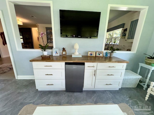 2367 Greenbrier Blvd, Pensacola, FL 32514 - bar area featuring refrigerator and baseboards