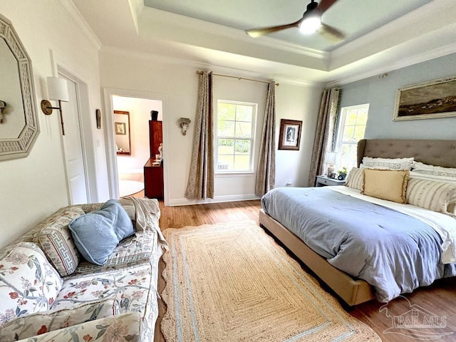 2367 Greenbrier Blvd, Pensacola, FL 32514 - bedroom with a tray ceiling, wood finished floors, ornamental molding, a ceiling fan, and baseboards