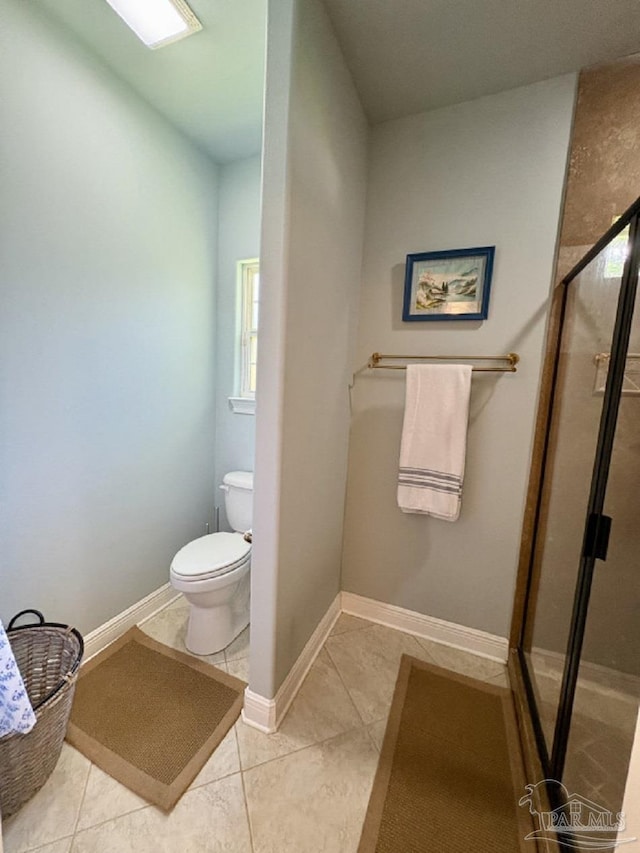 2367 Greenbrier Blvd, Pensacola, FL 32514 - bathroom featuring toilet, a shower stall, tile patterned flooring, and baseboards
