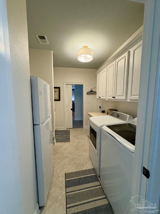 2367 Greenbrier Blvd, Pensacola, FL 32514 - washroom featuring independent washer and dryer, cabinet space, light tile patterned floors, and baseboards