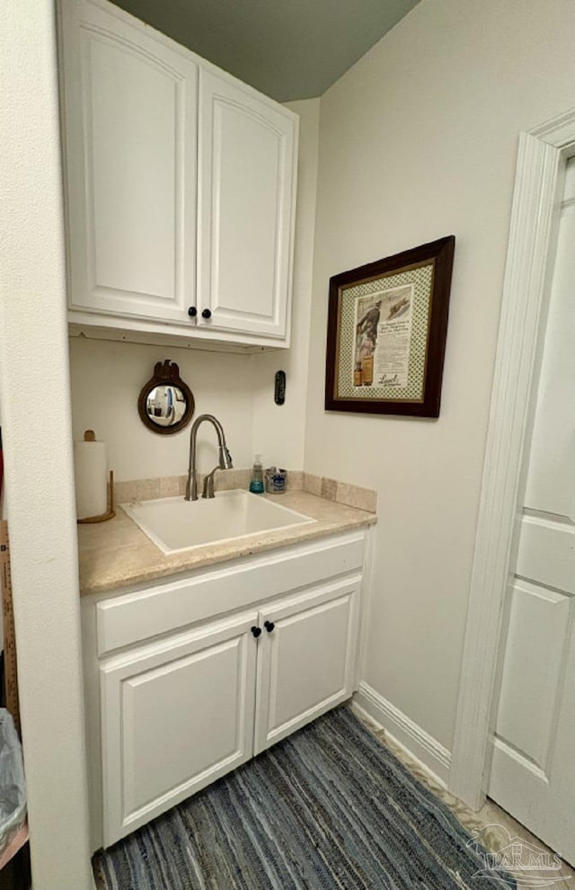 2367 Greenbrier Blvd, Pensacola, FL 32514 - washroom with a sink and baseboards
