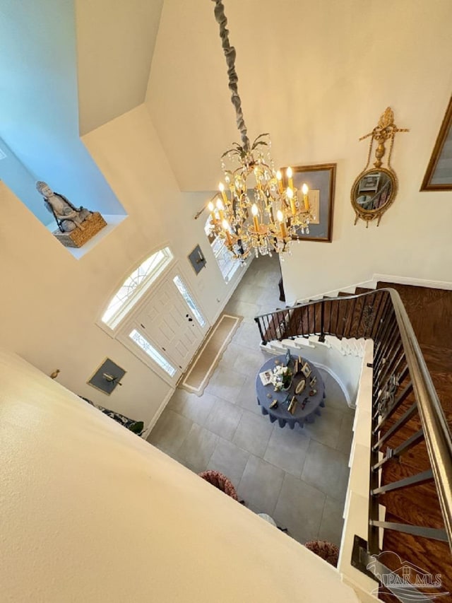 2367 Greenbrier Blvd, Pensacola, FL 32514 - staircase featuring a high ceiling, a chandelier, and tile patterned floors