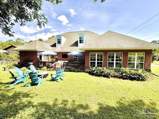 2367 Greenbrier Blvd, Pensacola, FL 32514 - back of house with a yard, brick siding, a wooden deck, and a shingled roof