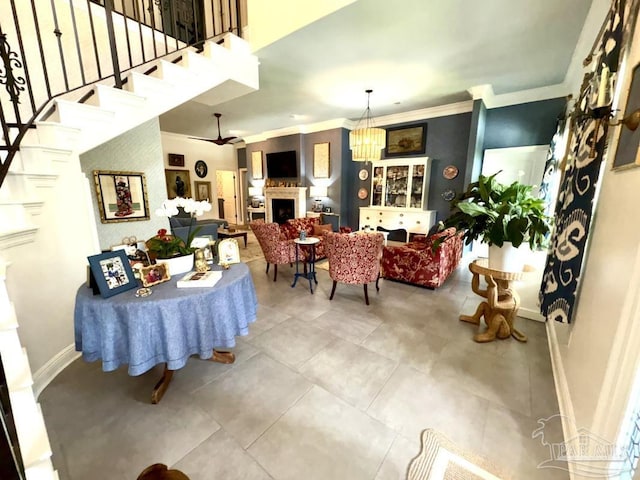 2367 Greenbrier Blvd, Pensacola, FL 32514 - living area with a fireplace, baseboards, ornamental molding, stairway, and tile patterned flooring