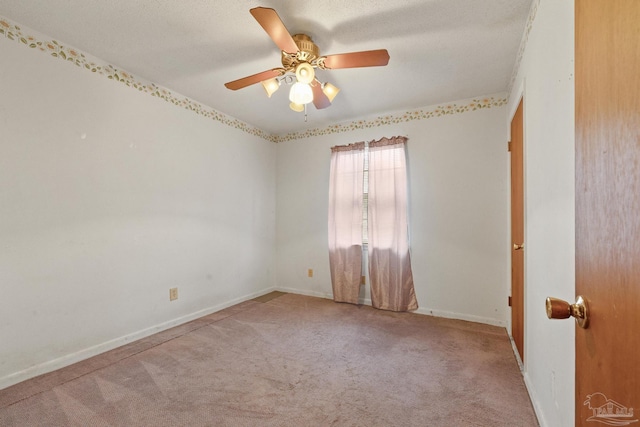 empty room featuring ceiling fan and light colored carpet