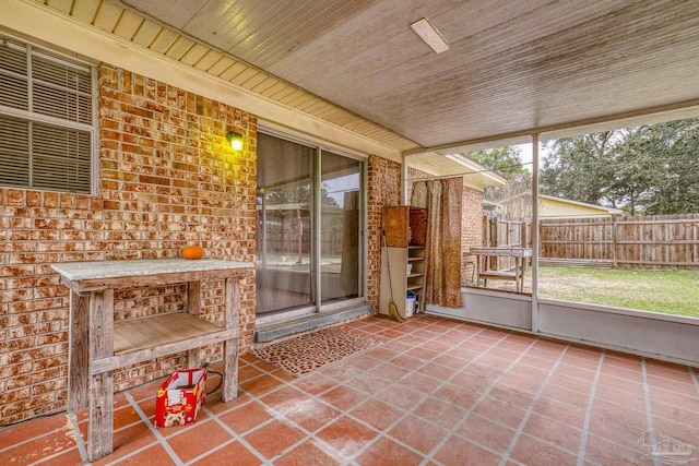 unfurnished sunroom featuring wood ceiling