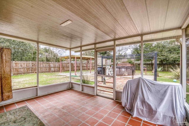 unfurnished sunroom featuring wood ceiling