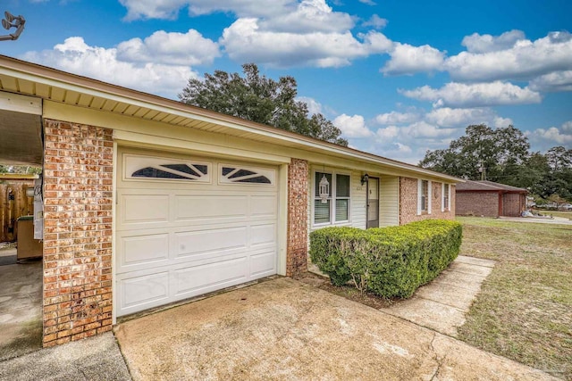 ranch-style house featuring a front yard and a garage