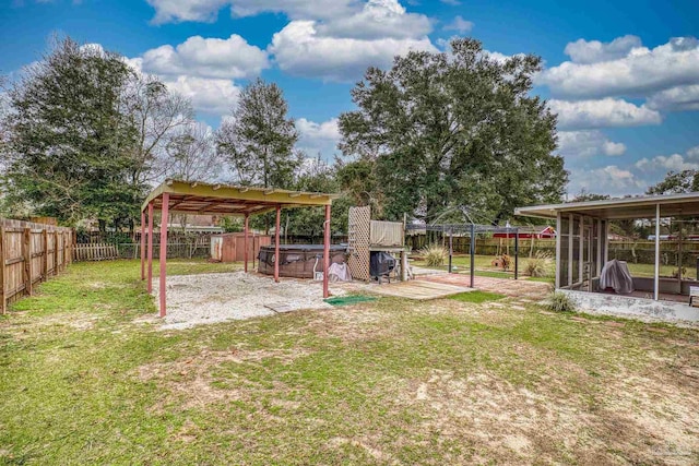 view of yard with a patio, a hot tub, and a sunroom