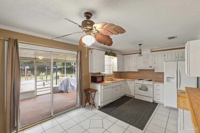 kitchen featuring plenty of natural light, white cabinetry, white appliances, and sink