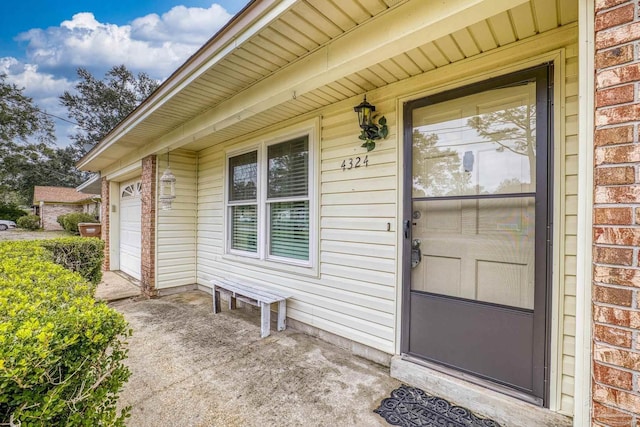 doorway to property with a garage