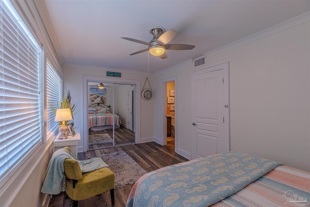 bedroom with ceiling fan, wood finished floors, visible vents, a closet, and crown molding