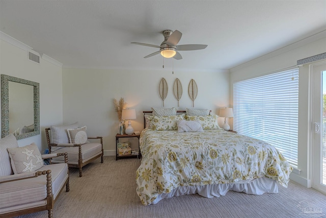 carpeted bedroom featuring baseboards, a ceiling fan, visible vents, and crown molding