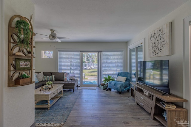 living room featuring ceiling fan and wood finished floors