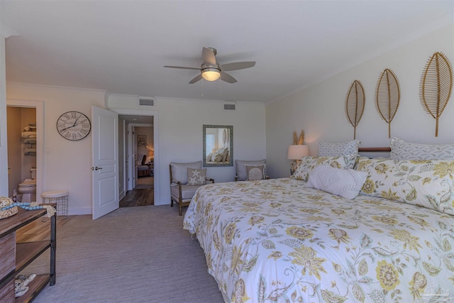 carpeted bedroom with ornamental molding, visible vents, and a ceiling fan