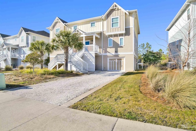 6548 Carlinga Dr, Pensacola, FL 32507 - view of front of house featuring board and batten siding, stairway, covered porch, and gravel driveway