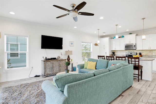 6548 Carlinga Dr, Pensacola, FL 32507 - living room with crown molding, ceiling fan, recessed lighting, and light wood-style floors