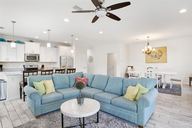 6548 Carlinga Dr, Pensacola, FL 32507 - living area featuring recessed lighting, crown molding, visible vents, wood tiled floor, and ceiling fan with notable chandelier