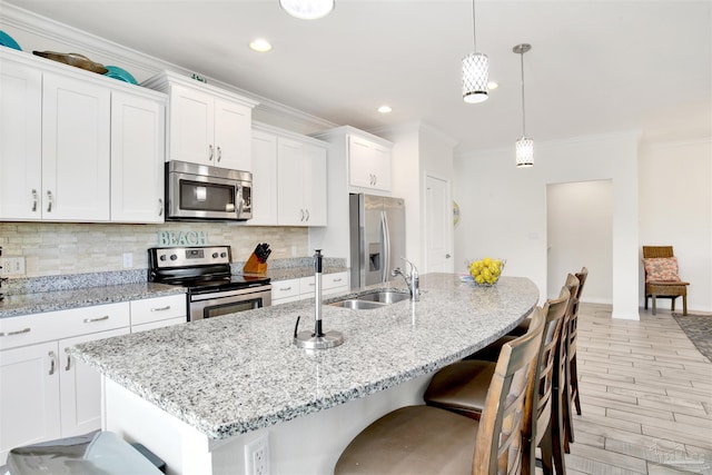 6548 Carlinga Dr, Pensacola, FL 32507 - kitchen with a sink, ornamental molding, an island with sink, and stainless steel appliances