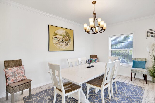 6548 Carlinga Dr, Pensacola, FL 32507 - dining room featuring a chandelier, light wood finished floors, baseboards, and crown molding