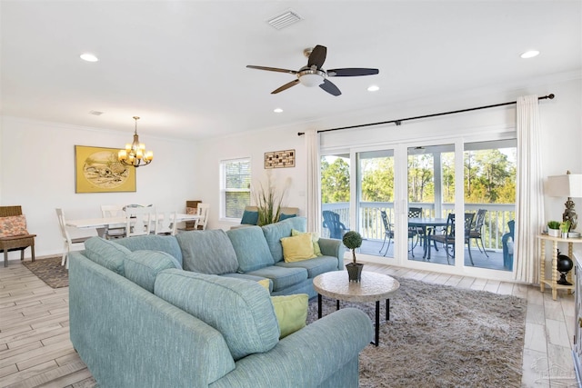 6548 Carlinga Dr, Pensacola, FL 32507 - living room with light wood finished floors, visible vents, ceiling fan with notable chandelier, and ornamental molding