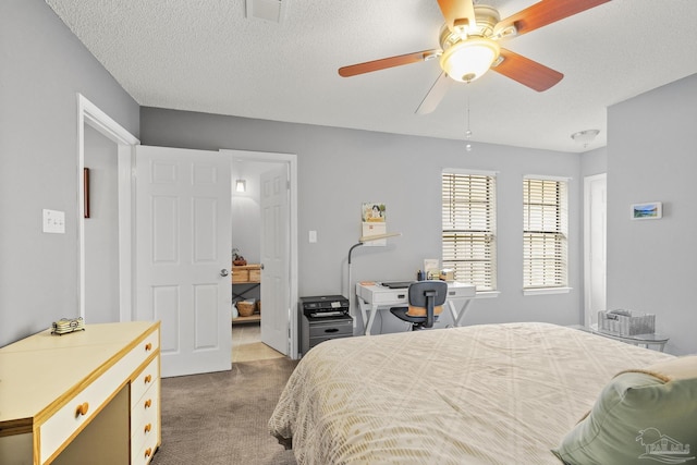 carpeted bedroom with a textured ceiling and ceiling fan